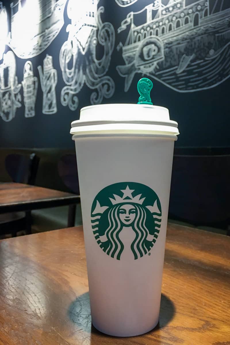 cup of starbucks coffee on table inside starbucks restaurant