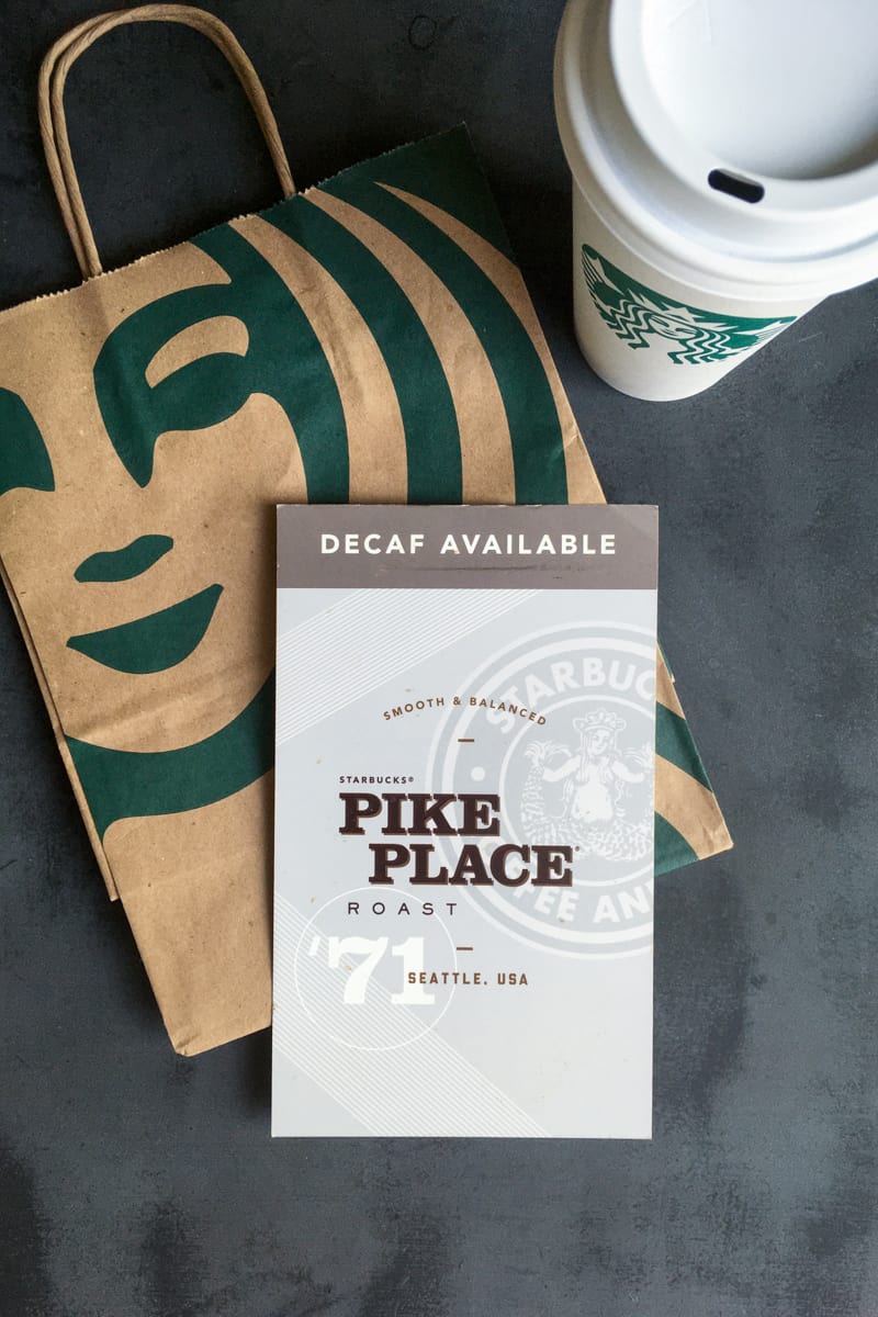 Starbucks decaf Pike Place coffee sign and drink.