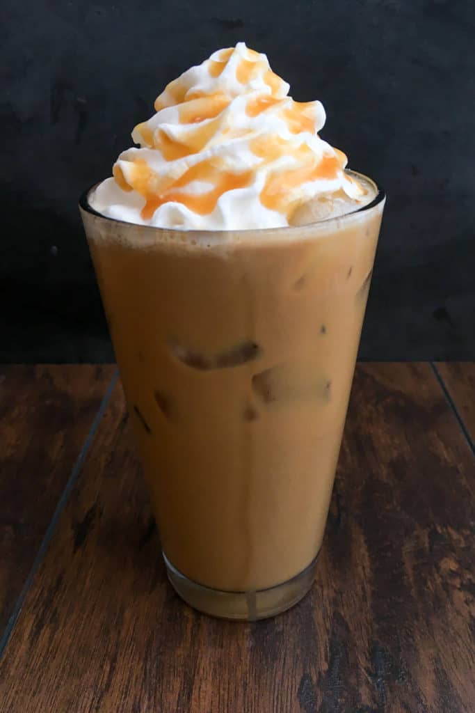 starbucks whipped cream made at home on top of iced coffee with caramel sauce drizzled on top