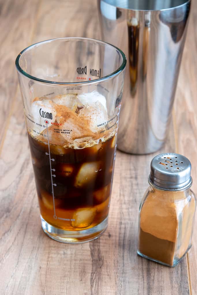 Cinnamon powder gets shaken into brown sugar espresso.