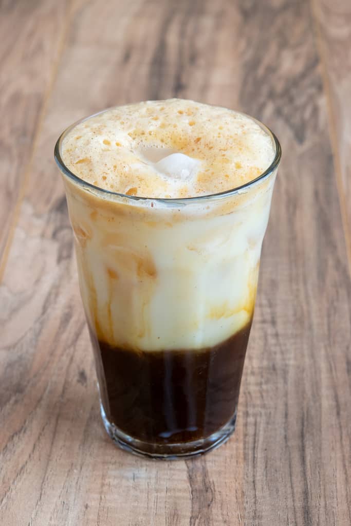 Layered Iced Shaken Brown Sugar Espresso with foam, oat milk and espresso.