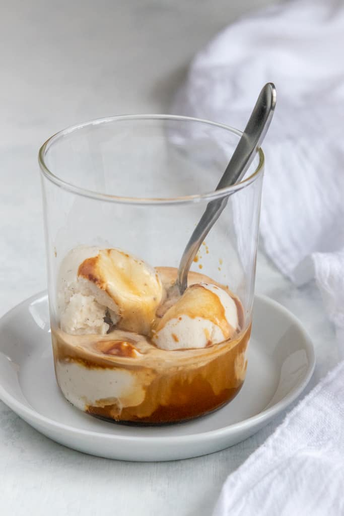 Espresso affogato dessert in cup with demitasse spoon.