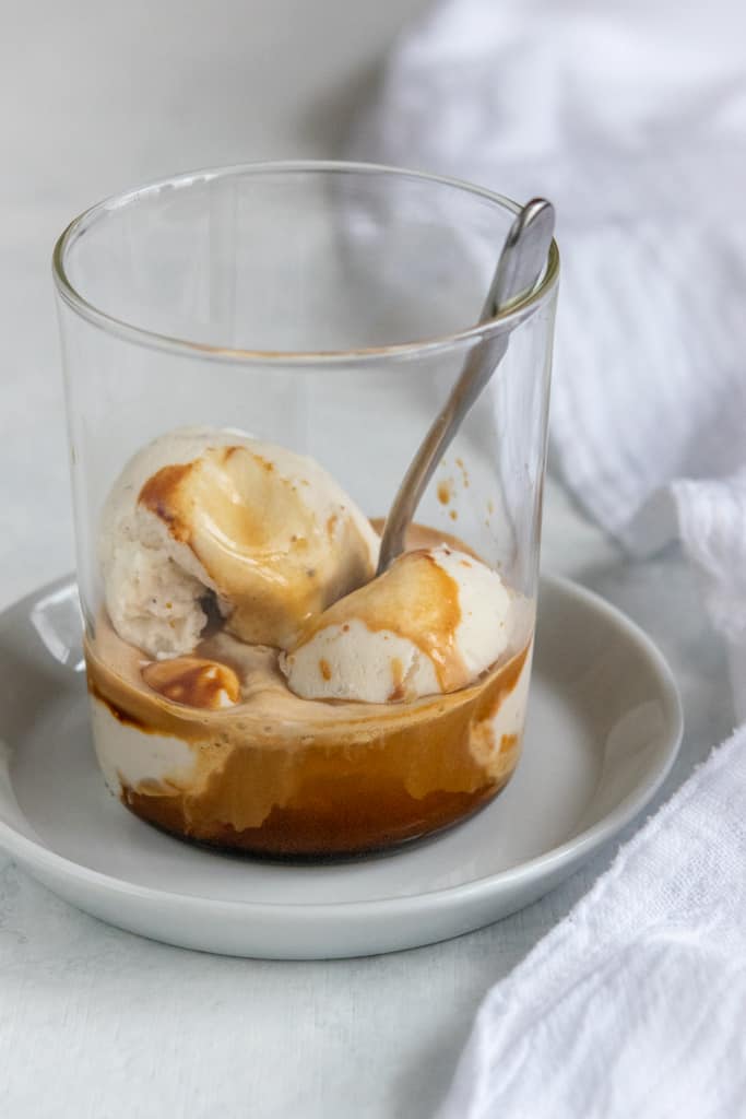 Affogato in small glass with demitasse espresso spoon in cup.