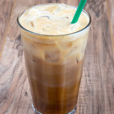 Starbucks copycat Iced Brown Sugar Oatmilk Shaken Espresso in glass with green straw.