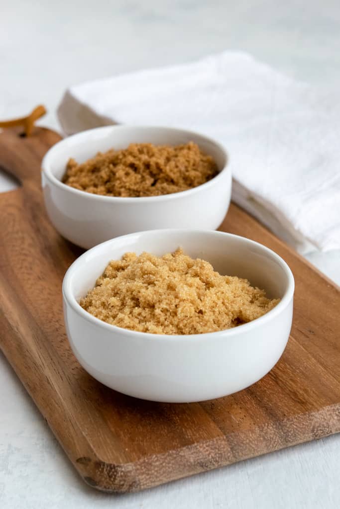 Bowl of light brown sugar compared to bowl of dark brown sugar.