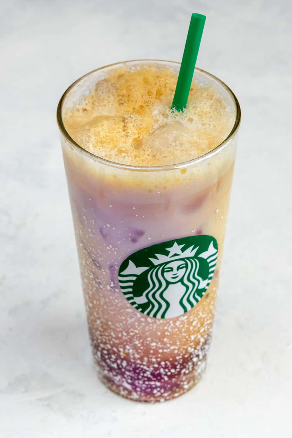 Homemade Iced Shaken Espresso in Starbucks glass with straw.