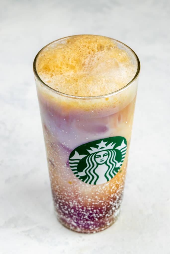 Iced Shaken Espresso made at home with layers of foam, milk, ice and espresso.
