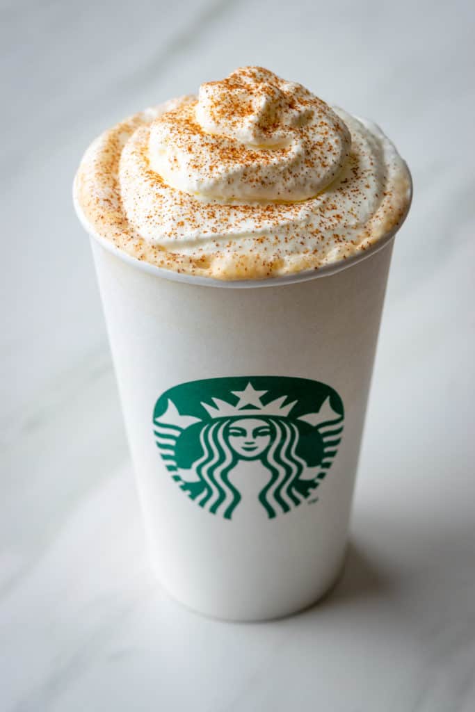 A Starbucks Pumpkin Spice Latte with whipped cream and pumpkin spice topping.