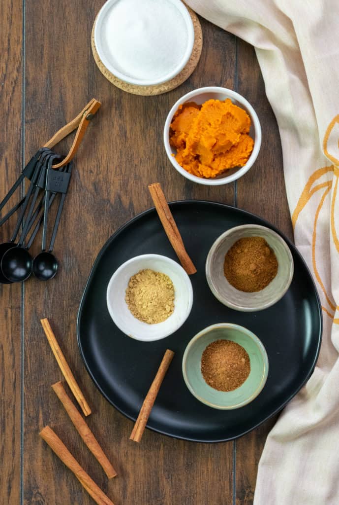 Bowls of ingredients to make homemade pumpkin spice syrup.