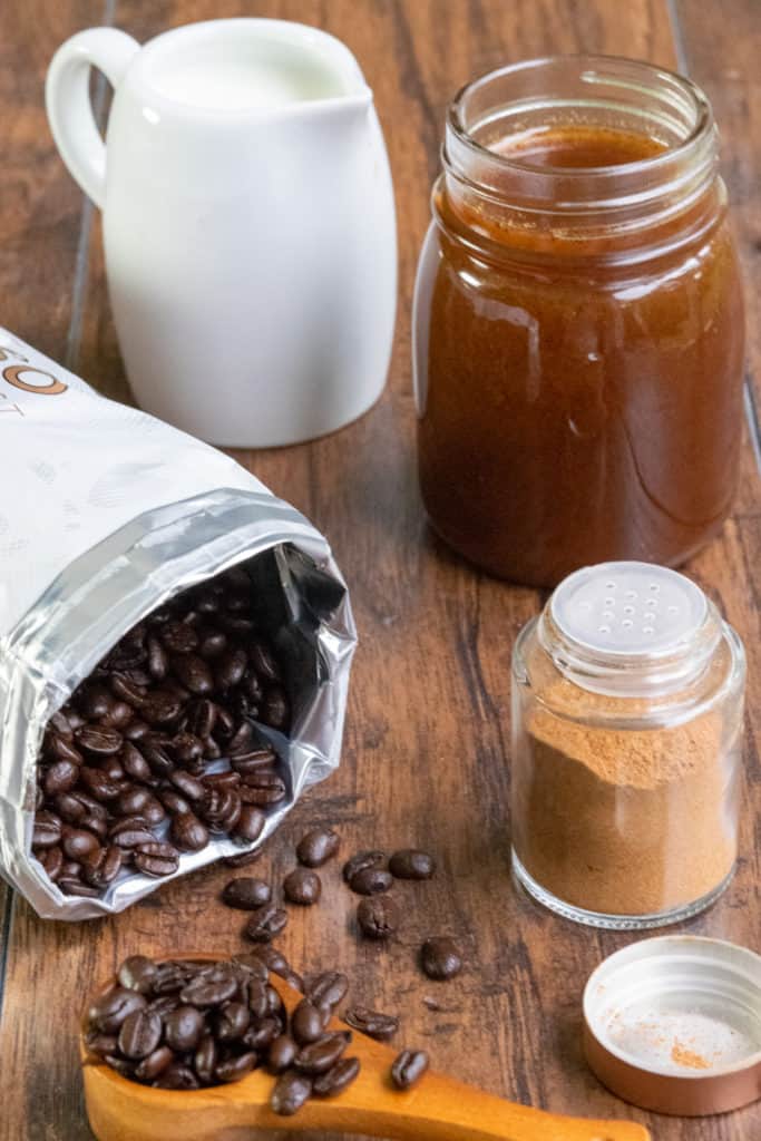 Homemade pumpkin spice syrup and espresso beans to make a pumpkin spice latte.