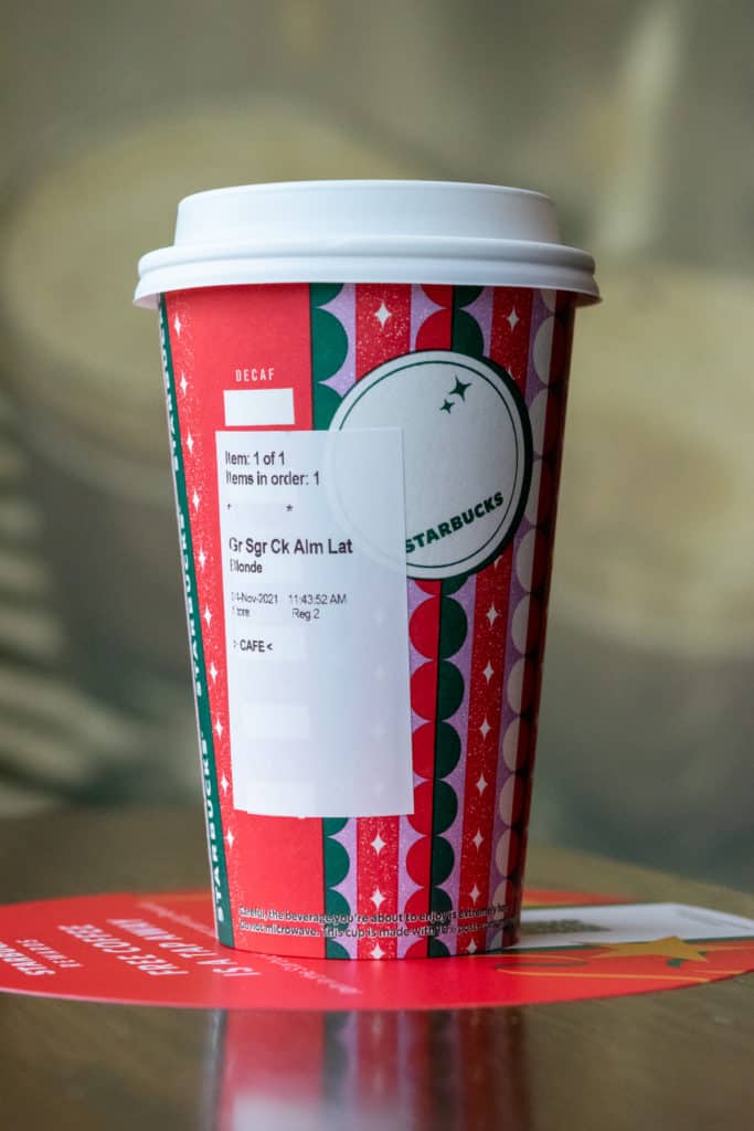 Grande Starbucks Sugar Cookie Almondmilk Latte in a holiday cup.