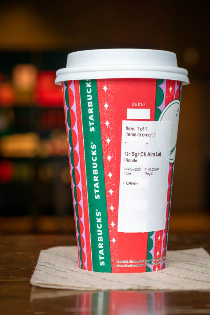 Sugar Cookie Almondmilk Latte in Starbucks red cup.