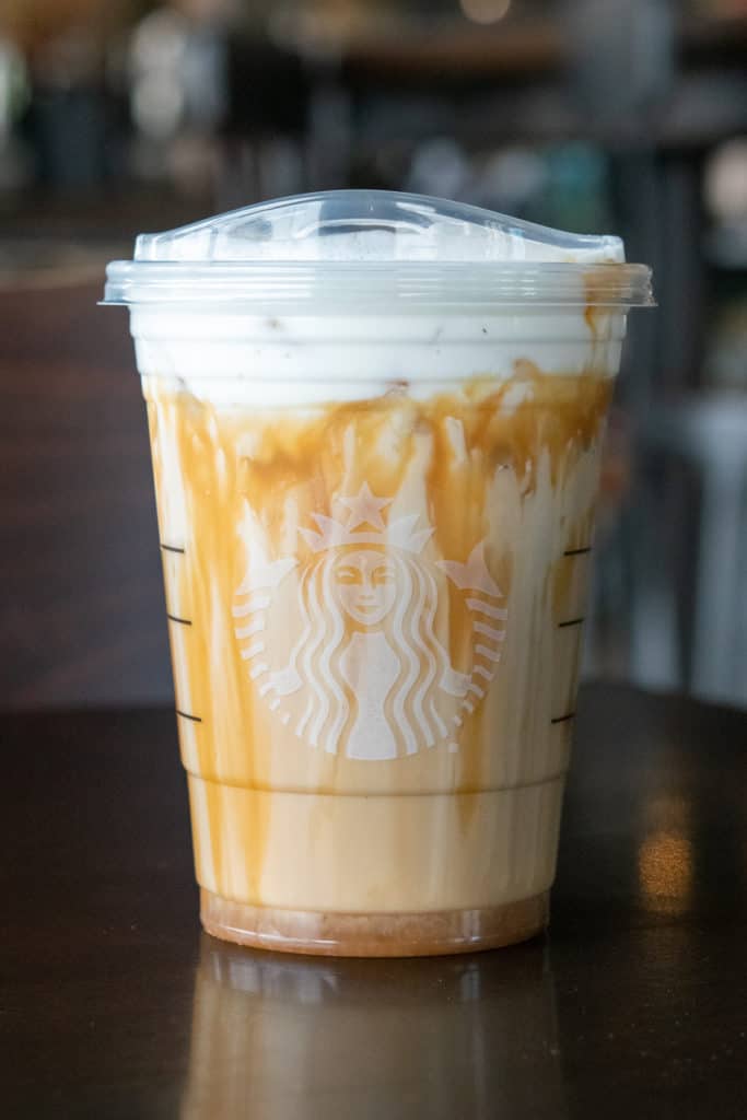 Starbucks TikTok Iced White Mocha drink topped with vanilla sweet cream cold foam and caramel syup.