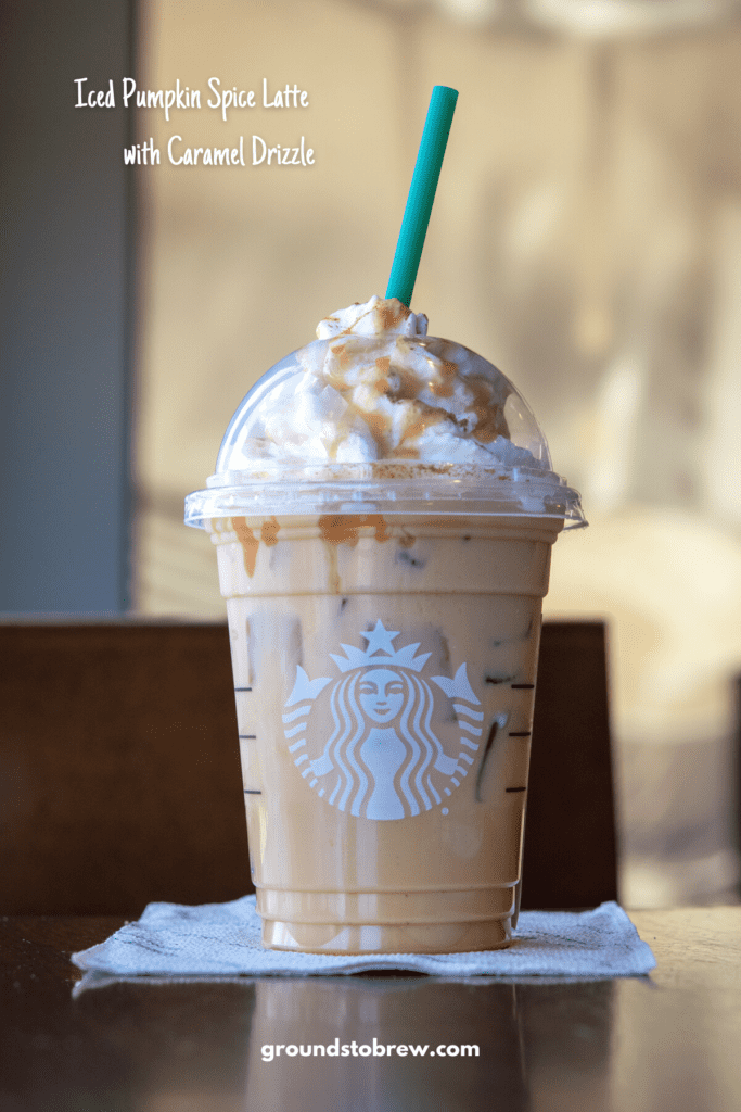 Pumpkin iced coffee drink at Starbucks with caramel drizzled on top.