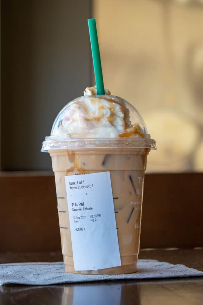 Iced Pumpkin Spice Latte with caramel and whipped cream.