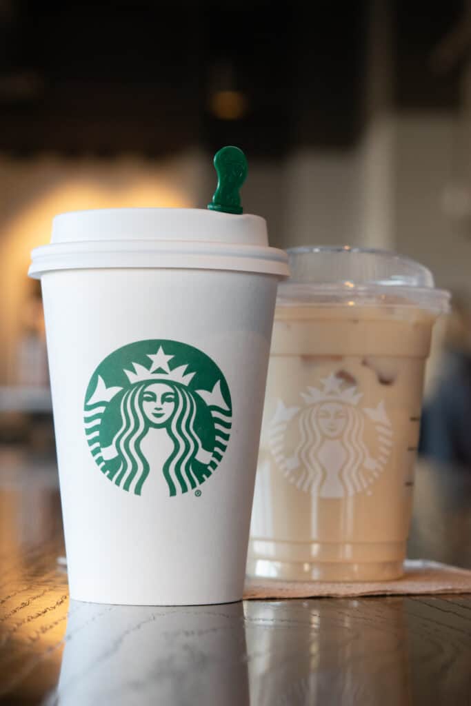 A hot Starbucks latte and an iced latte both in tall size cups containing 75mg caffeine each.