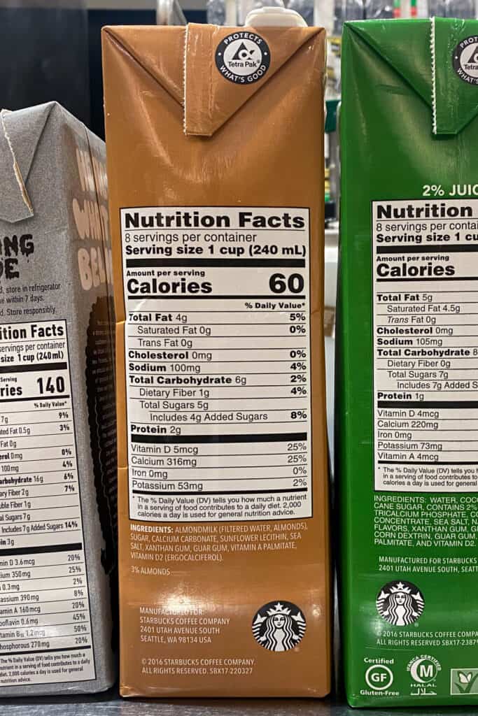 Starbucks almond milk container showing complete nutrition facts and ingredients.