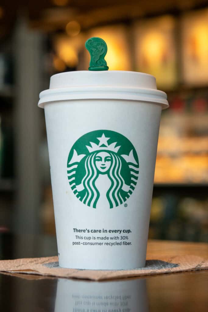 A tall Starbucks hot drink with lid on.