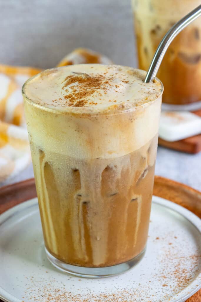 A homemade brown sugar shaken espresso with a thick layer of pumpkin cold foam and pumpkin spice on top.