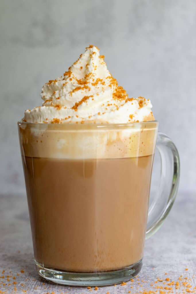 A homemade cookie butter latte topped with whipped cream and Biscoff cookie crumble.