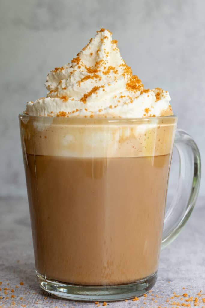 Cookie butter latte with a big topping of whipped cream and crushed Lotus Biscoff cookies.