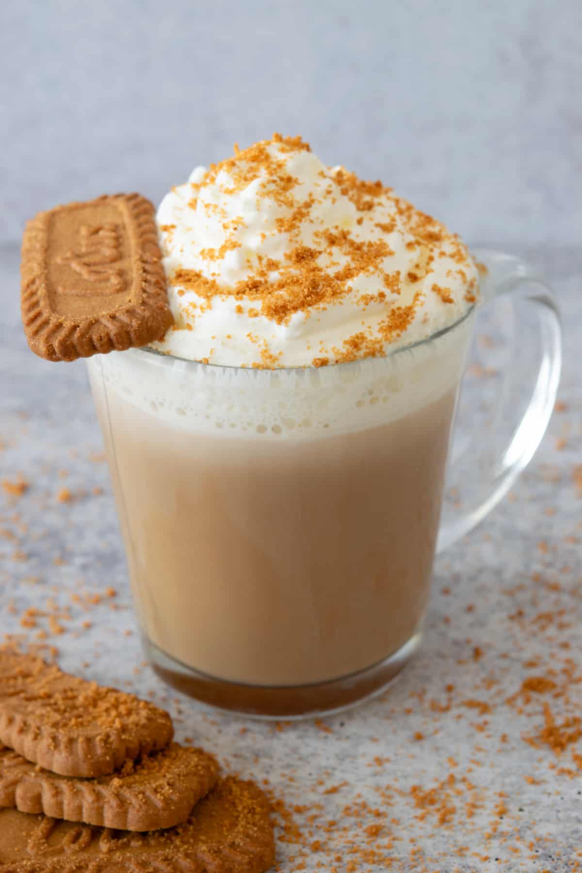 Homemade cookie butter latte with a Biscoff cookie sitting on the edge of the mug.