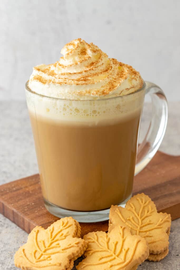A maple latte and three maple leaf shaped maple syrup cookies.