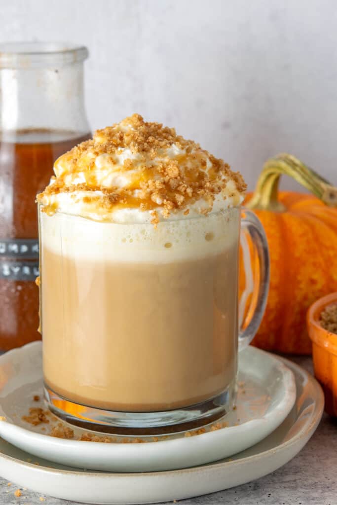 A layered pumpkin spice pie latte topping with caramel drizzle and lots of pie crust crumbles.