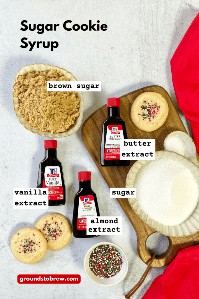 Overhead picture showing all the ingredients needed to make sugar cookie coffee syrup, including white sugar, light brown sugar, vanilla extract, butter extract, and almond extract.