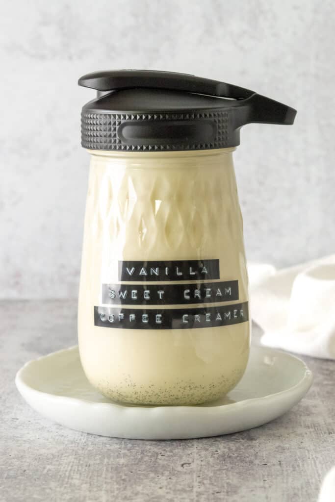 Homemade vanilla sweet cream coffee creamer in a glass bottle.