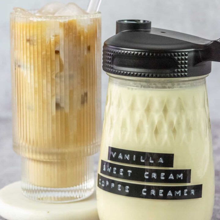 Bottle of homemade vanilla sweet cream coffee creamer and an iced coffee drink mixed with the creamer.