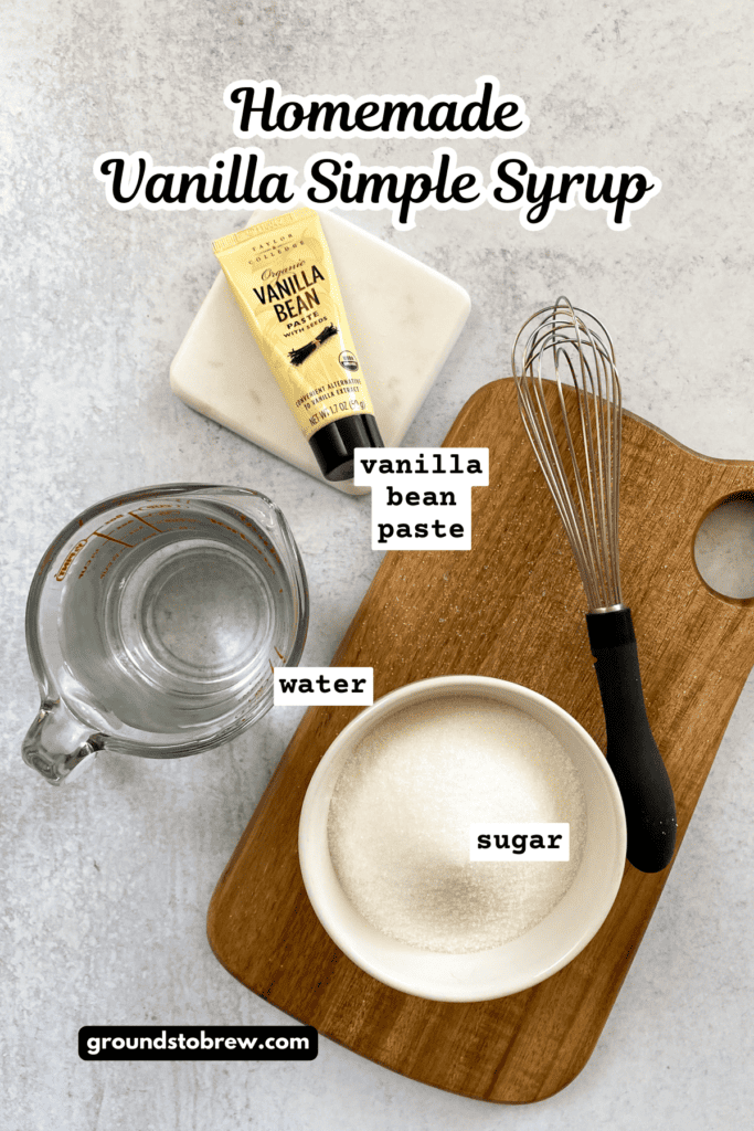Overhead picture showing a tube of vanilla bean paste, measuring cup with water and bowl of granulated sugar.