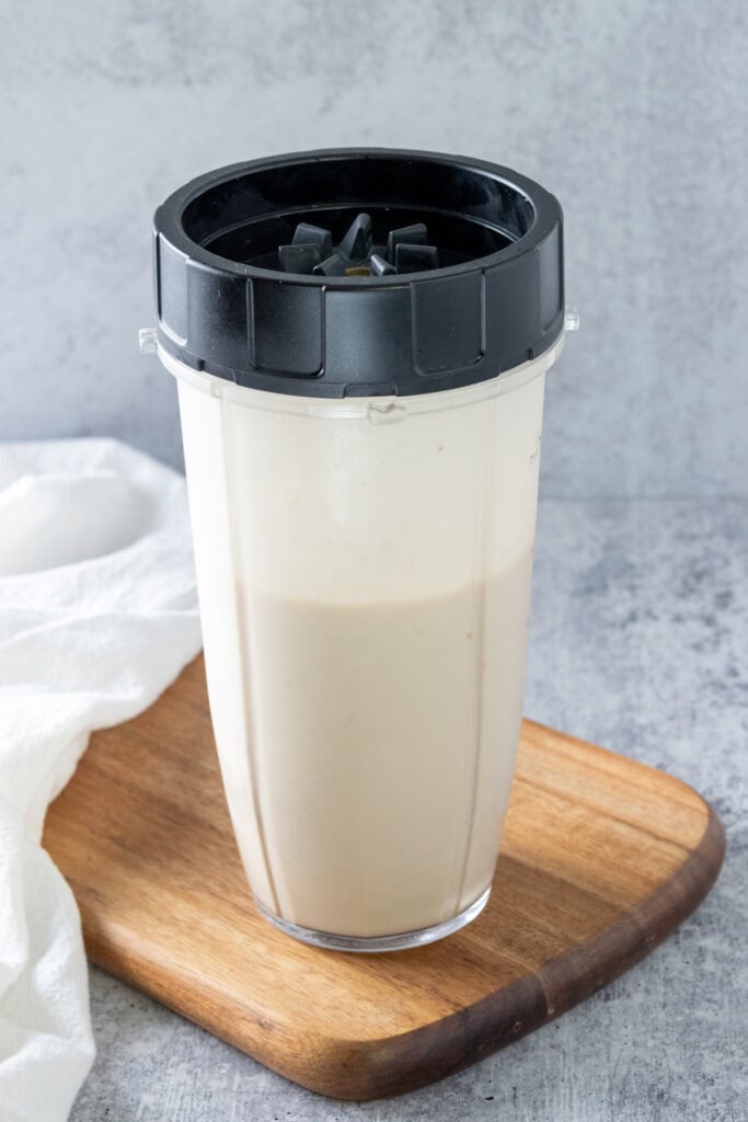 Blended coffee banana smoothie in blender cup.